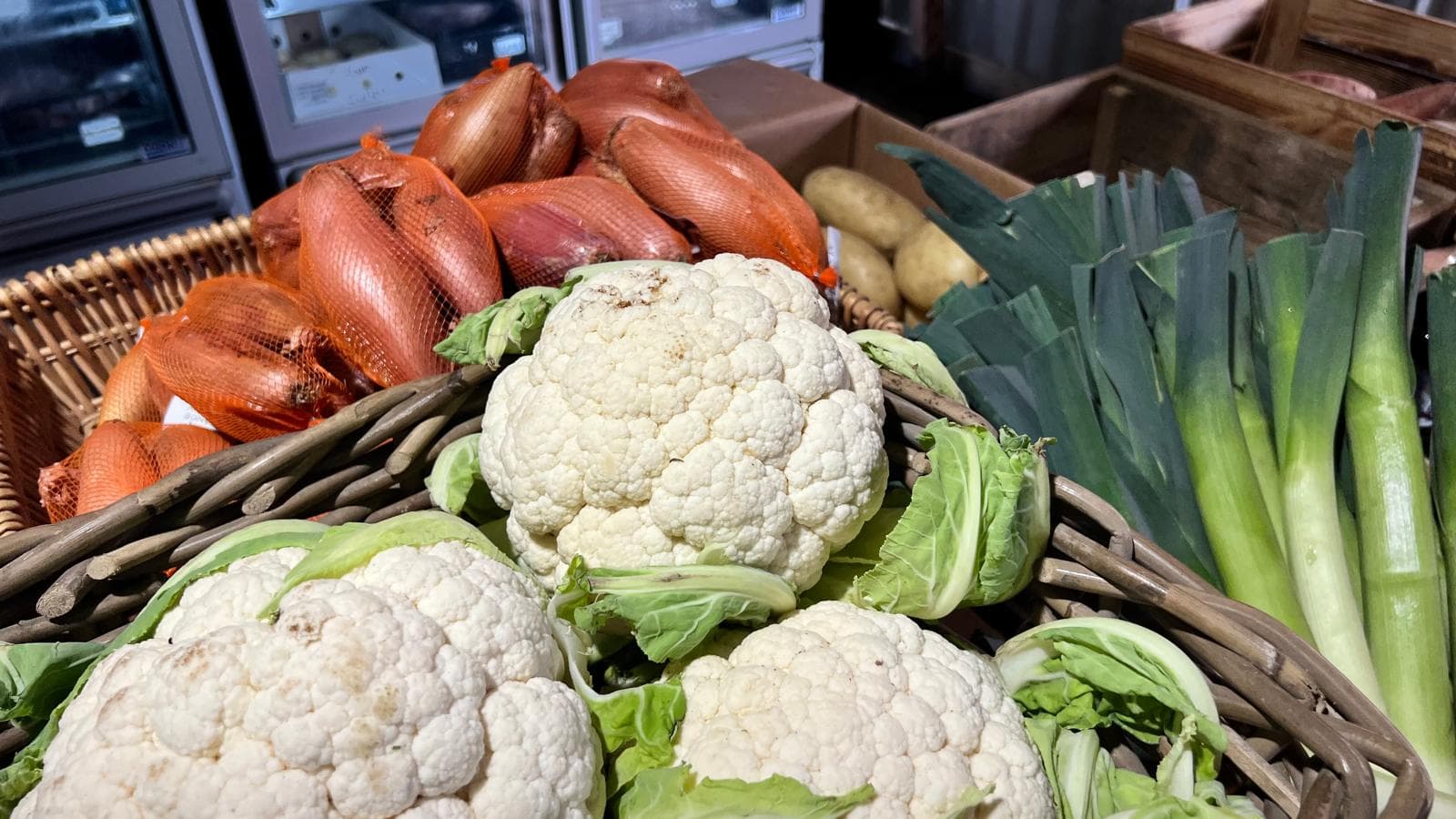 Cauliflowers, shallots and leeks on display in the farm shop